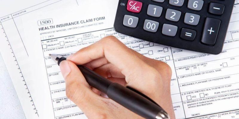 Person calculating health insurance coverage