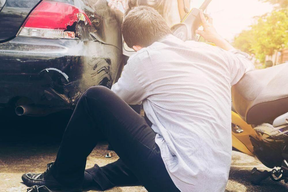 Man sitting on the ground next to