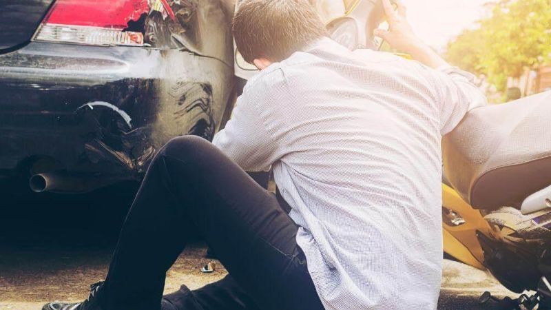 Man sitting on the ground next to