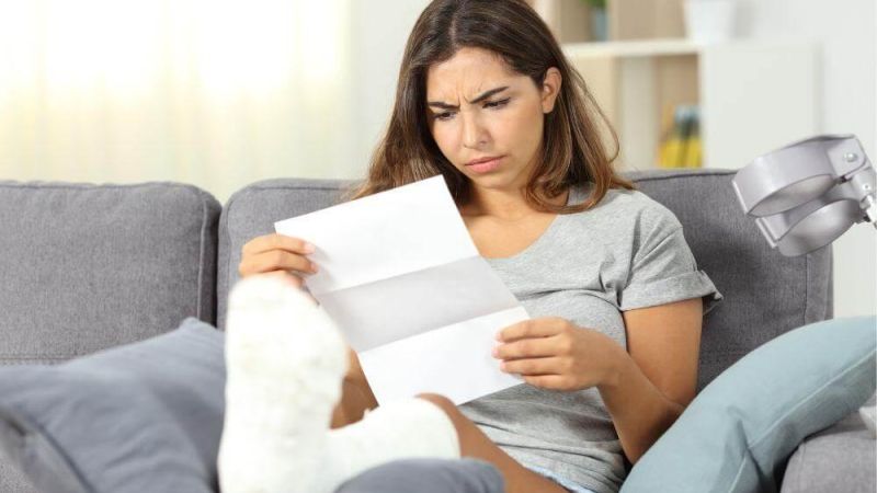 Woman reviewing personal injury settlement papers in Oklahoma